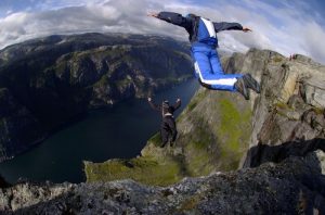 Person skydiving off cliff