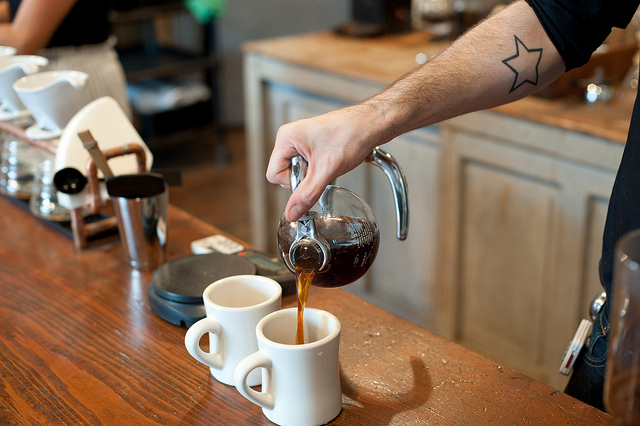 Barista pouring coffee