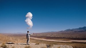 Man standing in open area with gun