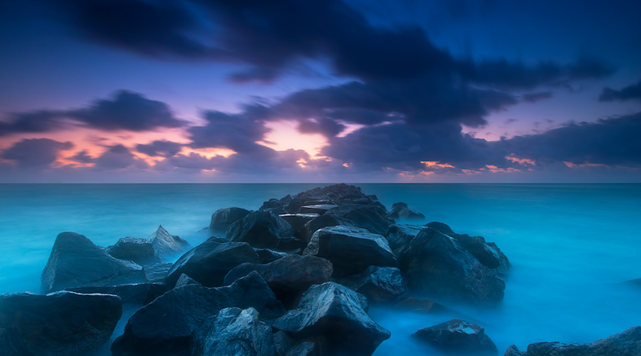 Rocks in water at sunset