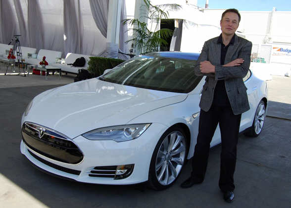 Elon Musk with a Tesla car