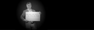 Adam Leipzig holding a sign